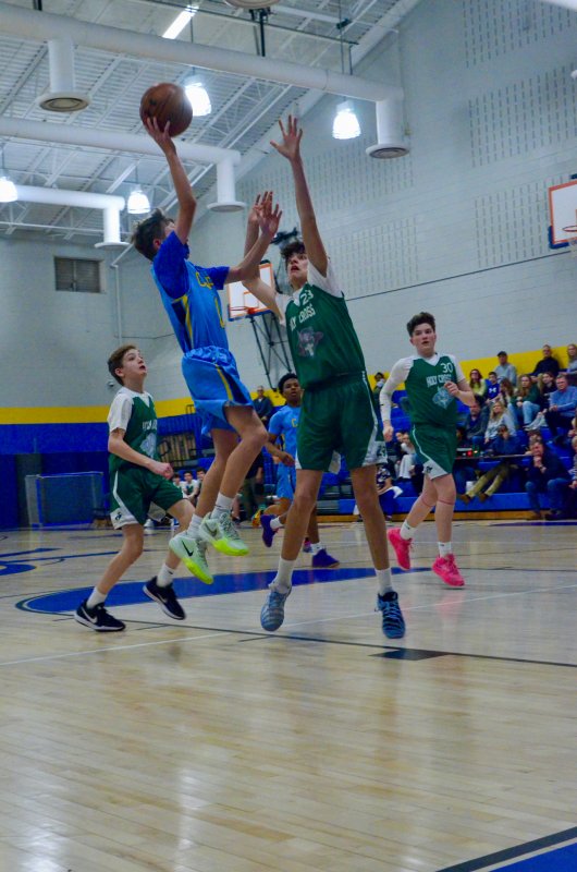 Beacon seventh-grader Lucas Skonieczki shoots with a defender in his face.
