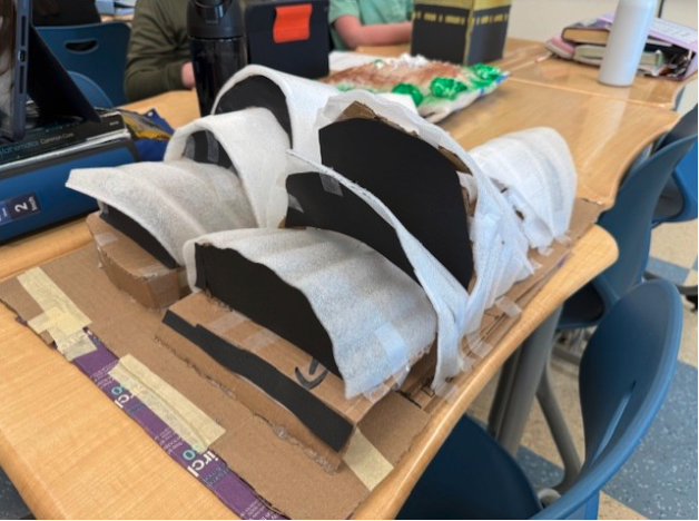 Beyer Sandvik used flexible packing sheets, cardboard and construction paper to build a scale model of the Sydney Opera House.