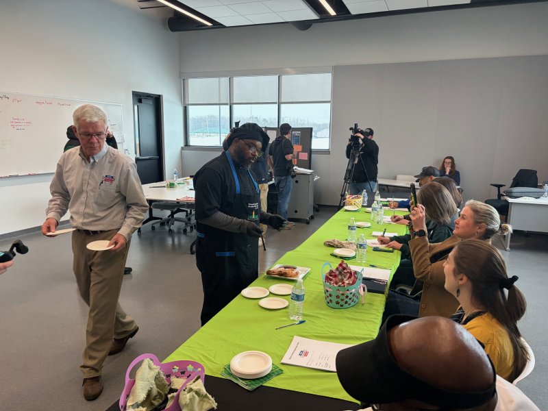 Ja’Quon Davis serves scrapple dogs, a handheld hot dog inspired by fair food, for the judges.