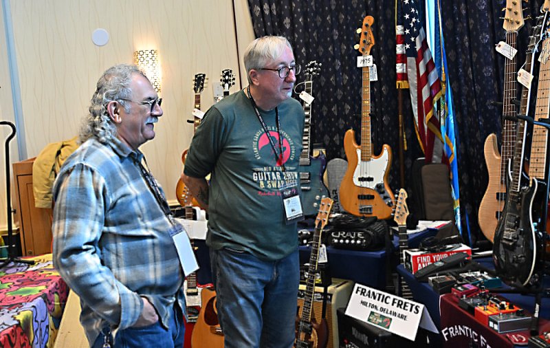 Sam Michael, left, speaks with Al Frantic as they admire Frantic Frets’ inventory during the 2025 show. DAN COOK PHOTO