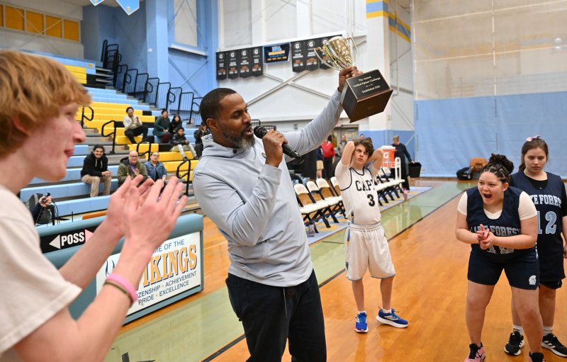 Lake coach Darrell Jones presents the Unified Partner Challenge Cup to the Spartans.