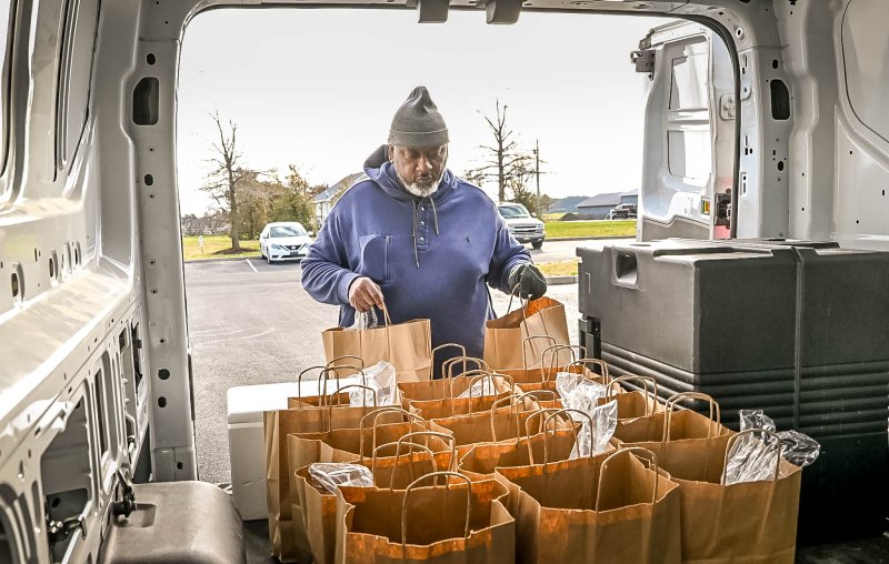 Edward Beckett loads the bags of meals to be delivered around Sussex County.