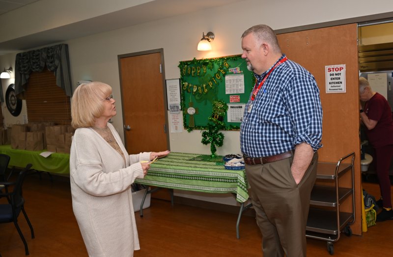 CHEER outreach worker Marion Poole, left, gives a daily report to CHEER Chief Operating Officer Tom Reardon.