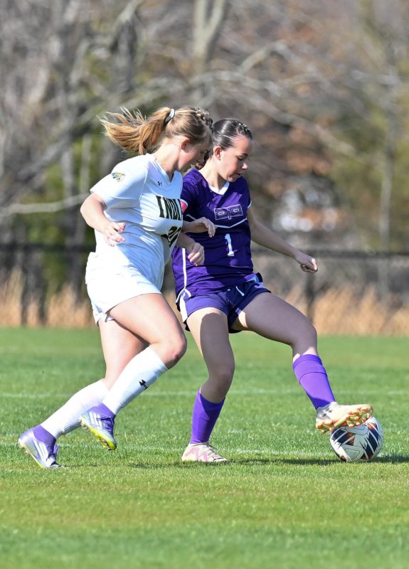 Royals senior HJaley Jones controls the ball away from IR defender Devyn Dowling.