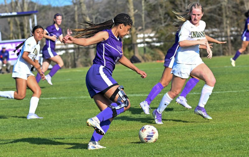 Eva Elliott passes the ball up the sideline.