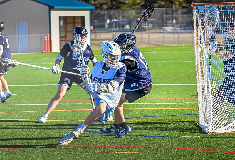 Pierce Conway dodges around the Bucs’ goal crease.
