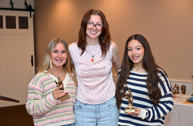 JV coach Carlin Quinn presents the Captain’s Award to Anna Neustadter, left, and Mia Scott.