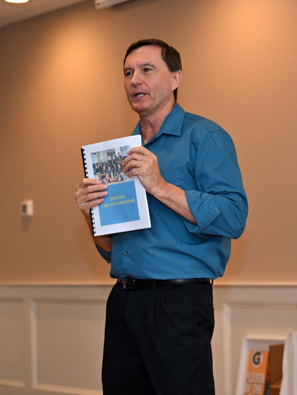 Cape coach Ron Dukes shows the gift of the season in articles for the varsity players.