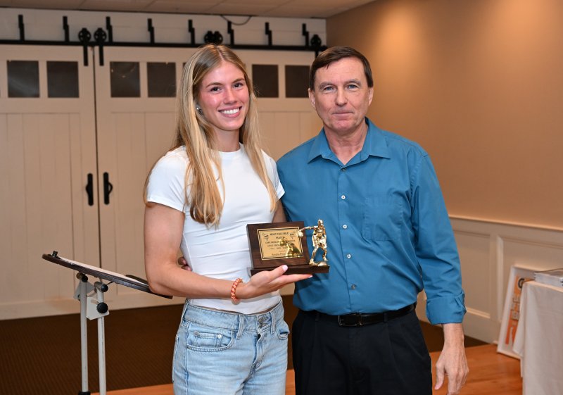 Senior Amalia Fruchtman receives the Team MVP Award from coach Ron Dukes.