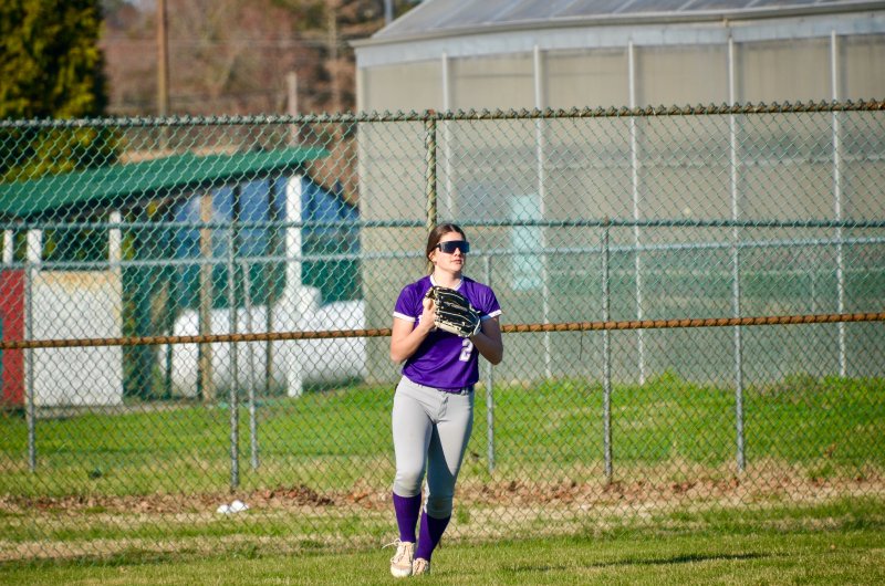 Royals senior Eve Bohinski begins to throw the ball in after tracking it down for an out.