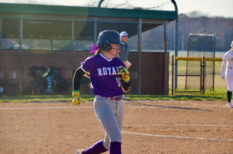 Delmarva Christian eighth-grader Carsyn Riddle keeps her eye on the outfield as she approaches first base.