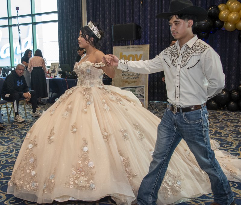 Ailyn Mercado is escorted by Dennis Juarez for the fashion show.