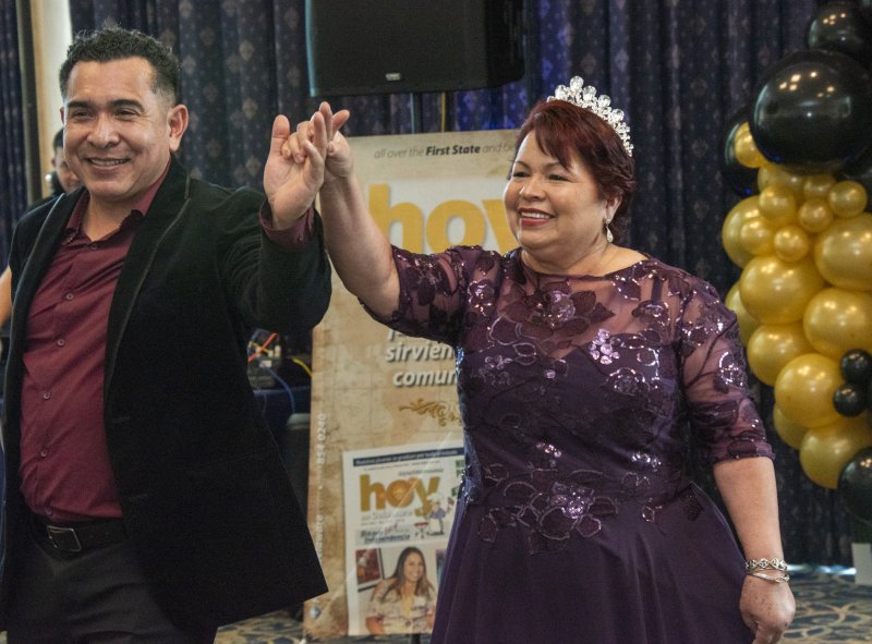 Fortunato Pérez escorts Irene Cordoba, who is honored for her delayed Quinceañera. She was unable to celebrate at age 15, but on her 65th birthday, she finally had her party.