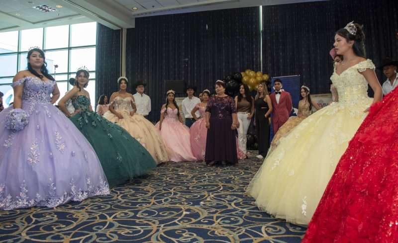 The young ladies and their escorts pose after the fashion show.