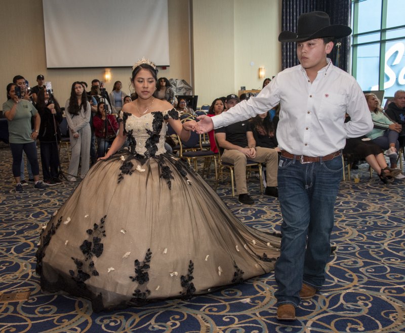 At the Miss XV Magazine Quinceañera Expo in Rehoboth Beach, Alison Velasquez is escorted on the runway by David Escobar. DENY HOWETH PHOTOS