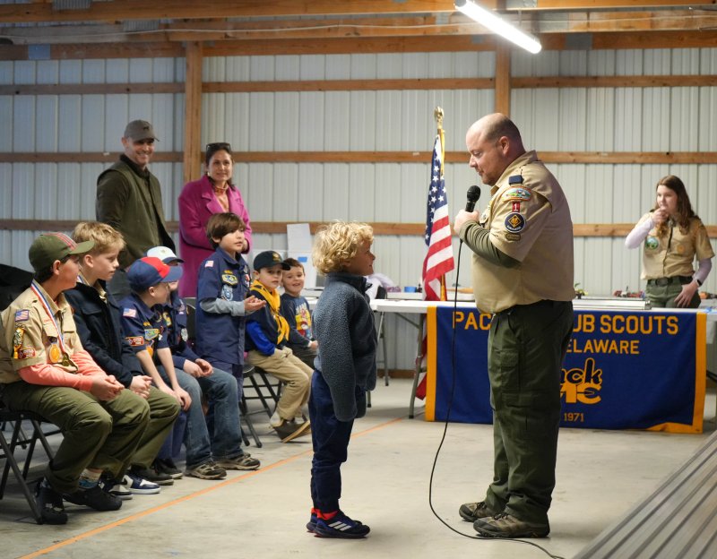 Pack 1 Lewes Cubmaster Chris Huebler asks Saylor McKinney, a Tiger Scout who ended up placing first in the derby, about the inspiration behind his car.