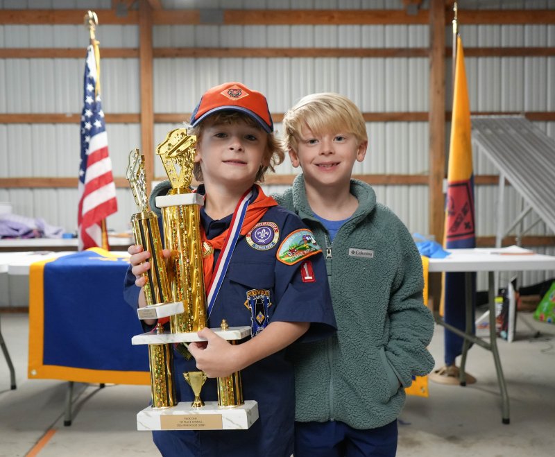 Tiger Scouts and brothers Saylor McKinney, left, and Sawyer McKinney stand together after Saylor’s first-place win at Pack 1’s 2026 Pinewood Derby.