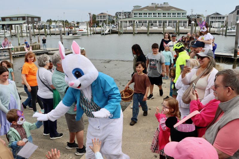 The Easter Bunny high-fives eager youngsters as he makes his way up from the Canalfront Park dock for the 2025 Bunny Bonanza. BILL SHULL PHOTO