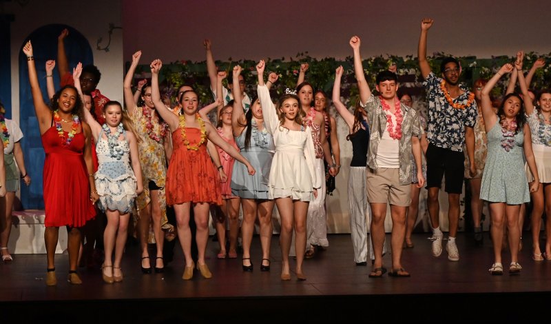 The cast performs a song together.