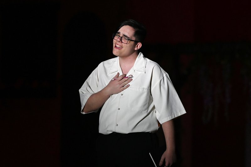 Daniel Cunningham performs a song as Sam Carmichael.