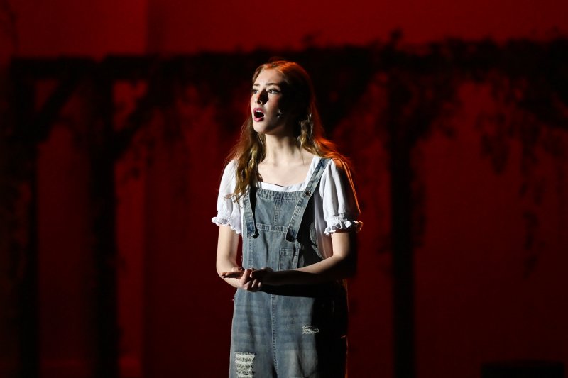 Daphne Mock sings a song as Donna.