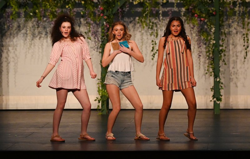 Bride-to-be Sophie, played by Willow DiMichele, center, sings a song with friends Lisa and Ali, played by Briana Vargas and Alayna Pastor.
