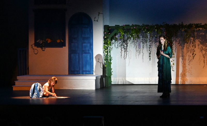 Charlotte Evans plays Little Sophie during a flashback while Daphne Mock sings a song as Donna.