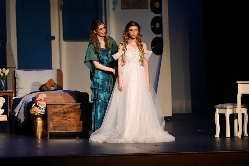 Mother and daughter get ready for the wedding. Donna, played by Daphne Mock, helps Sophie, played by Willow DiMichele, get her dress arranged.