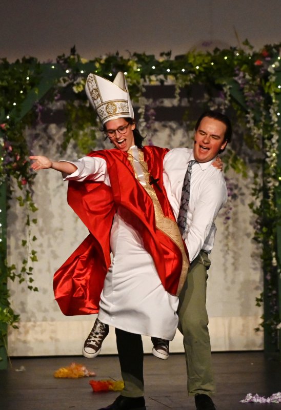 Father Alexandrios, played by Taylor Ruark, is lifted by Bill Austin, played by Noah Lewis, during “I Do, I Do, I Do, I Do, I Do.”