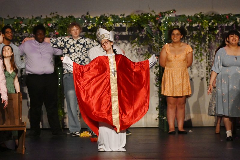 Father Alexandrios, played by Taylor Ruark, performs during “I Do, I Do, I Do, I Do, I Do.”