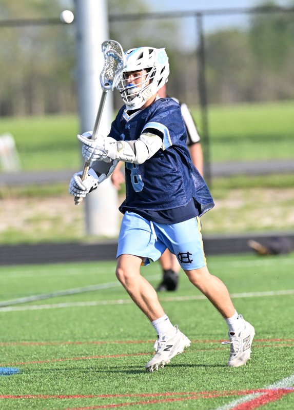 Vikings sophomore Pierce Conway passes to the crease.
