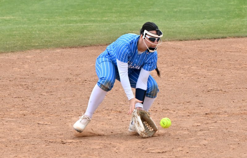 Freshman short stop Makaila Sellers scoops up a Red Lion ball and throws to first for an out.