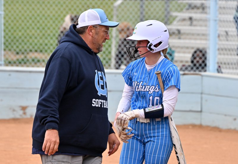 Cape coach Mike Tkach speaks with Olivia Mekulski before her at bat.