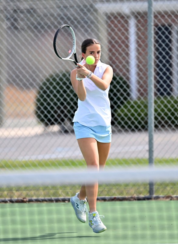 Kennedy Spath slams a backhand drive; she defeated Shama Estimable 6-0, 6-0 at second singles.