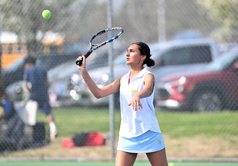 Anika Sehgal Sekhri goes for a forehand volley at first doubles.