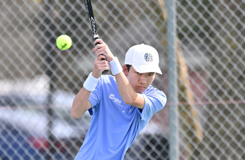 Nate Hoang hits a backhand drive at first singles.