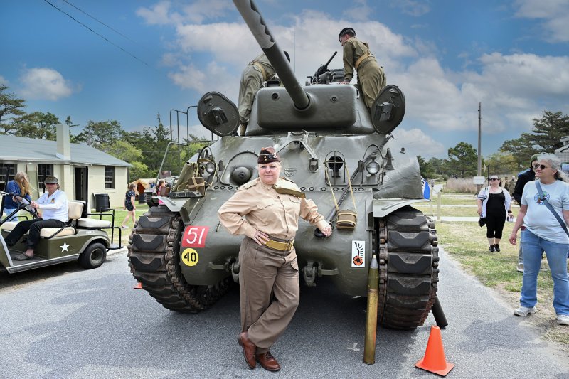 Reenactor Karen Rose stands with the Sherman tank on display during Delaware Defense Day 2025 at Fort Miles. DAN COOK PHOTO