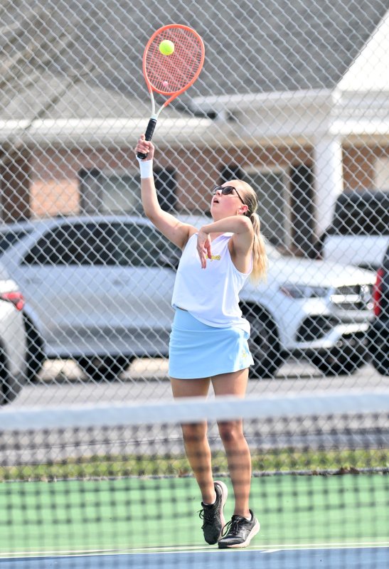 Ida Molzahn serves at third singles.