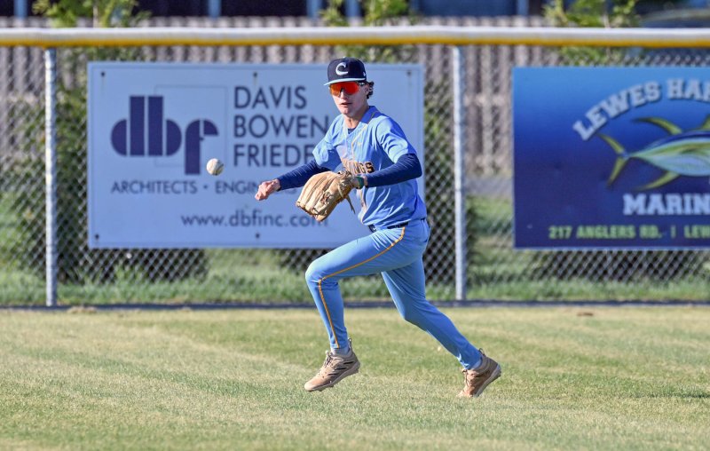 Cape senior Emmett Wheatley runs down a Ducks hit in the outfield.