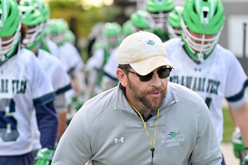 Delaware Tech head coach Dan Yearick leads his players onto the turf of battle.