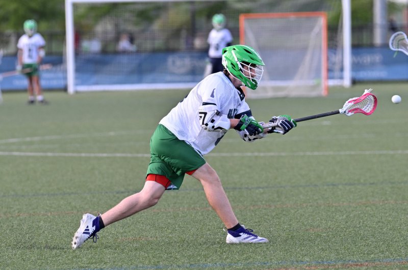 Del Tech middie Logan Hill (Woodbridge) shoots and scores.