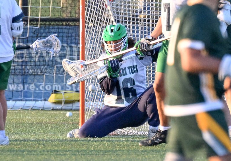 Del Tech goalie Jaden Parker (Dover) makes a save in a crowd.