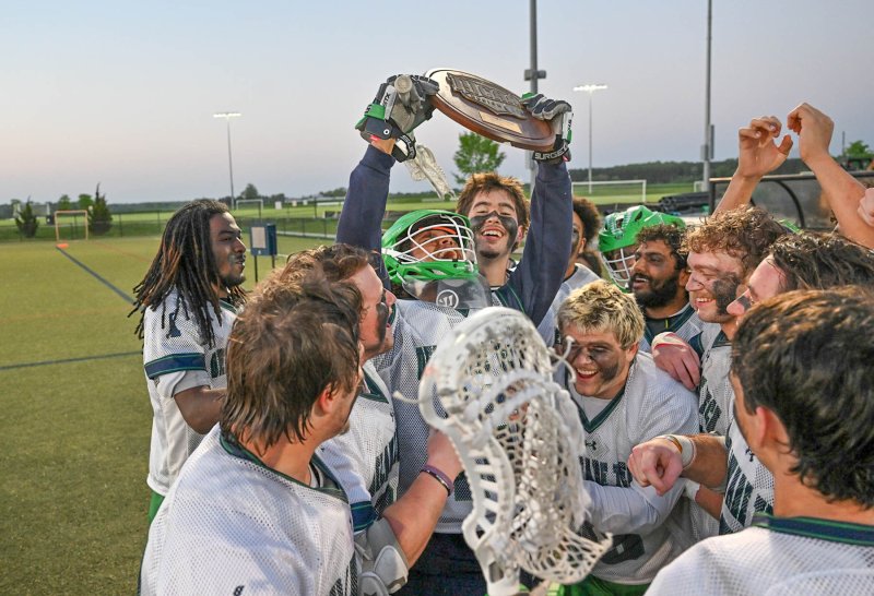 Delaware Tech goalie Jayden Parker hoists the Region 19 Championship plaque.