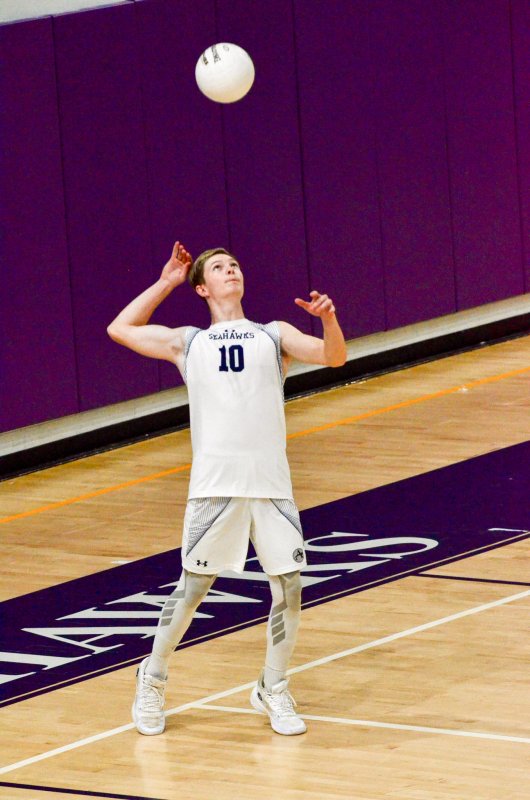 Sussex Academy senior Jerry Green serves the ball.