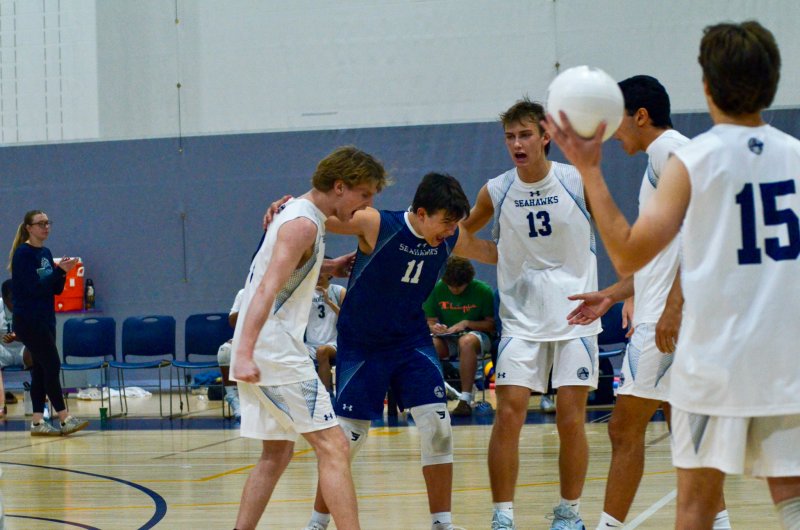 Sussex Academy’s Desmond Davis, Ethan Evans and Mack Lawson form a circle as senior Christian Wright and Vito Barone join in to celebrate Davis’ ace.