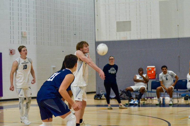 Sussex Academy junior Desmond Davis receives a serve.