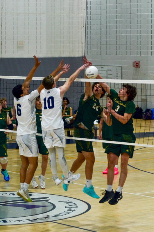 Sussex Academy senior Christian Wright, left, and Jerry Green engage with the enemy at the net.