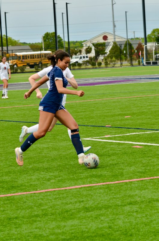 Sussex Academy junior Maya Hastings begins to cross the ball.
