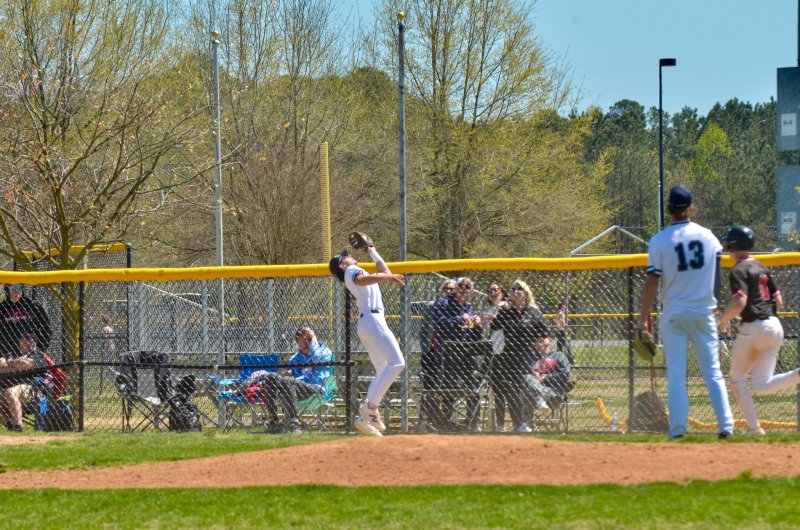 Sussex Academy sophomore Ben Tollett catches a pop up in foul territory.