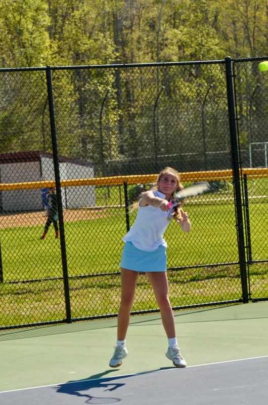 Cape junior Julia DiSabatino watches her serve.